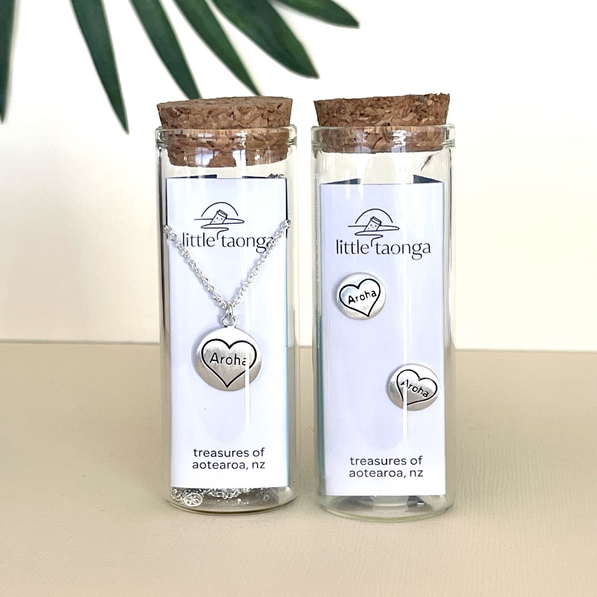 Aroha necklace and earrings set in glass bottle